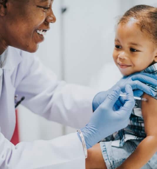 image of a doctor giving a girl her vaccination